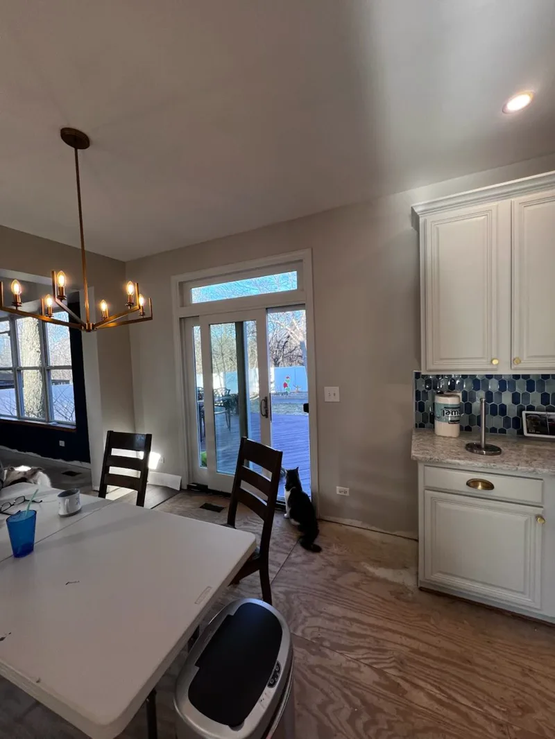 Kitchen with freshly painted white cabinets and dining table